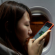Zhao talks to Wang Quanming on her phone after her plane lands in Quanzhou, in Fujian province on Jan 26.